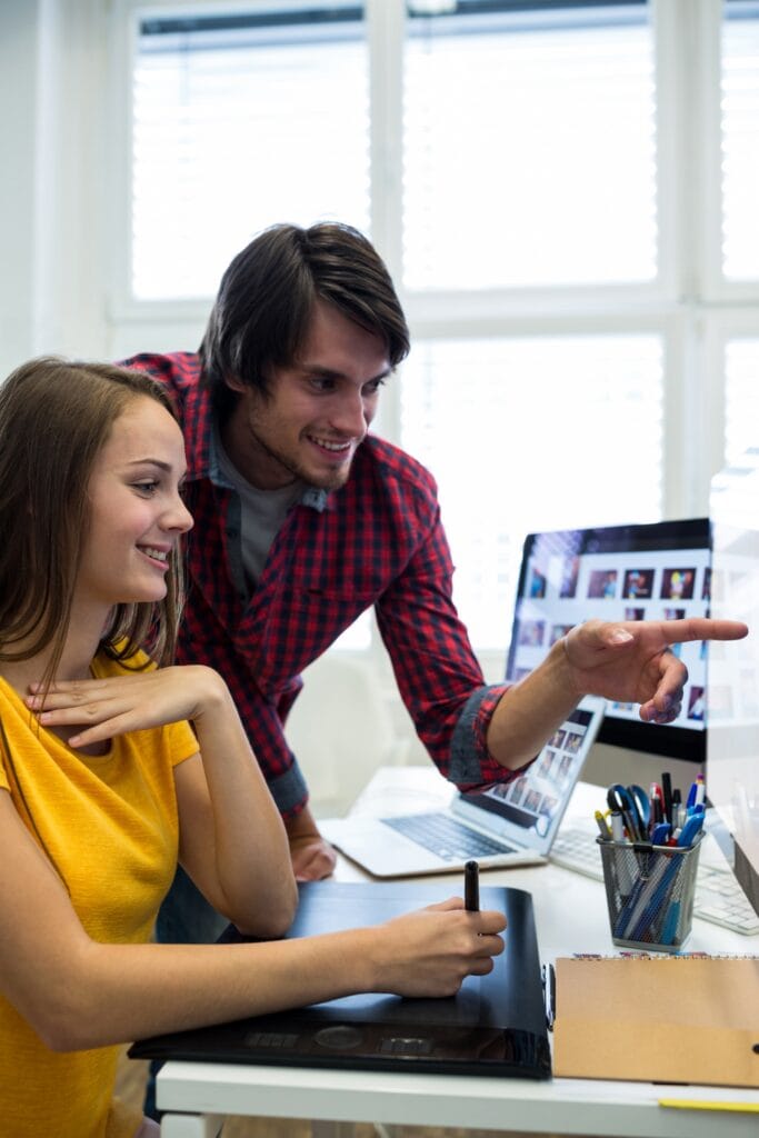 A man trying to show something to the girl